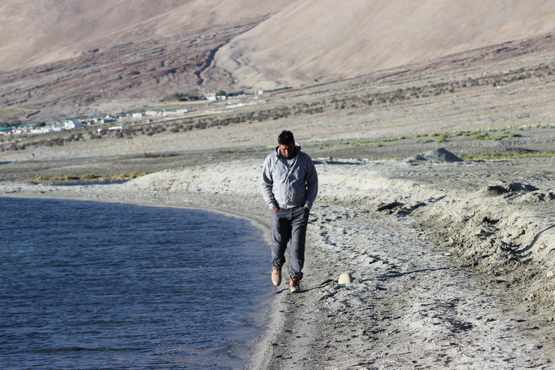 tranquil scene, land, beach, one person, day, nature, water, non-urban scene, blue, landscape, casual clothing, leh, holiday, lifestyles, beauty in nature