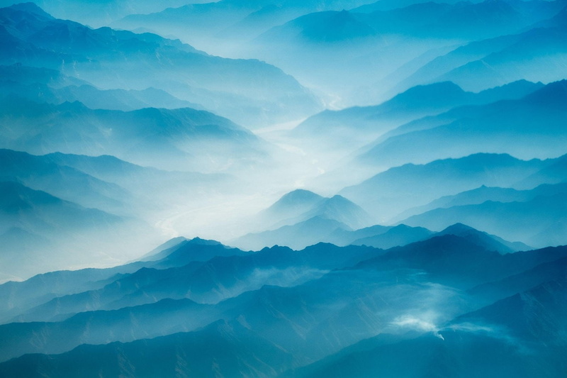 sky, majestic, morning, beauty in nature, tranquil scene, mountains, aerial view, landscape, no people, fog, cloud - sky, cyan, outdoors, idyllic, nature