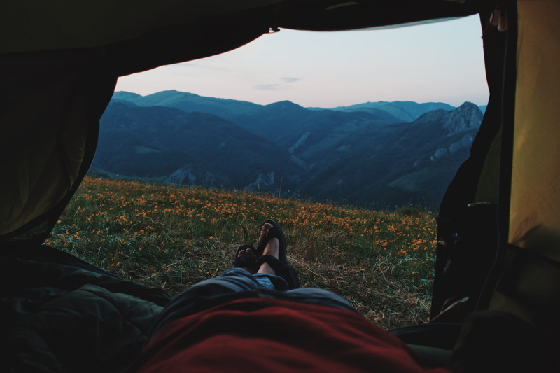 camping, person, personal perspective, mountain, blue, calm, yellow, beauty in nature, body part, unrecognizable person, legs, distant, human limb, taking