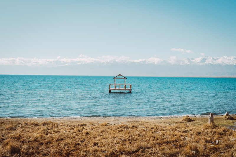 outdoors, no people, kul, issyk, grass, cloud - sky, lake, tranquil scene, kyrgyzstan, snow, idyllic, water, tranquility, beauty in nature, sky, sand, pier