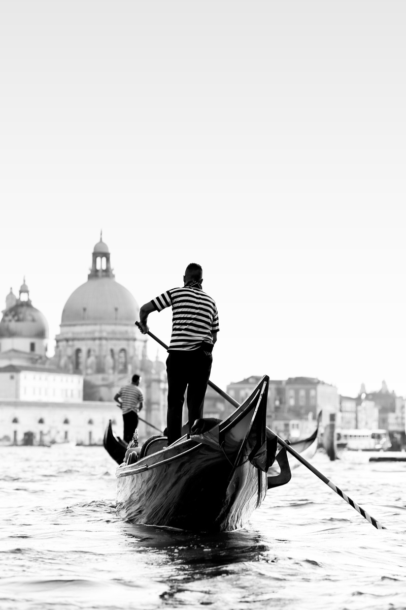 man, boat, neighborhood, nautical vessel, person, canal, day, architecture, paddle, urban, nature, building, vessel, housing, parliament, gondola - traditional boat