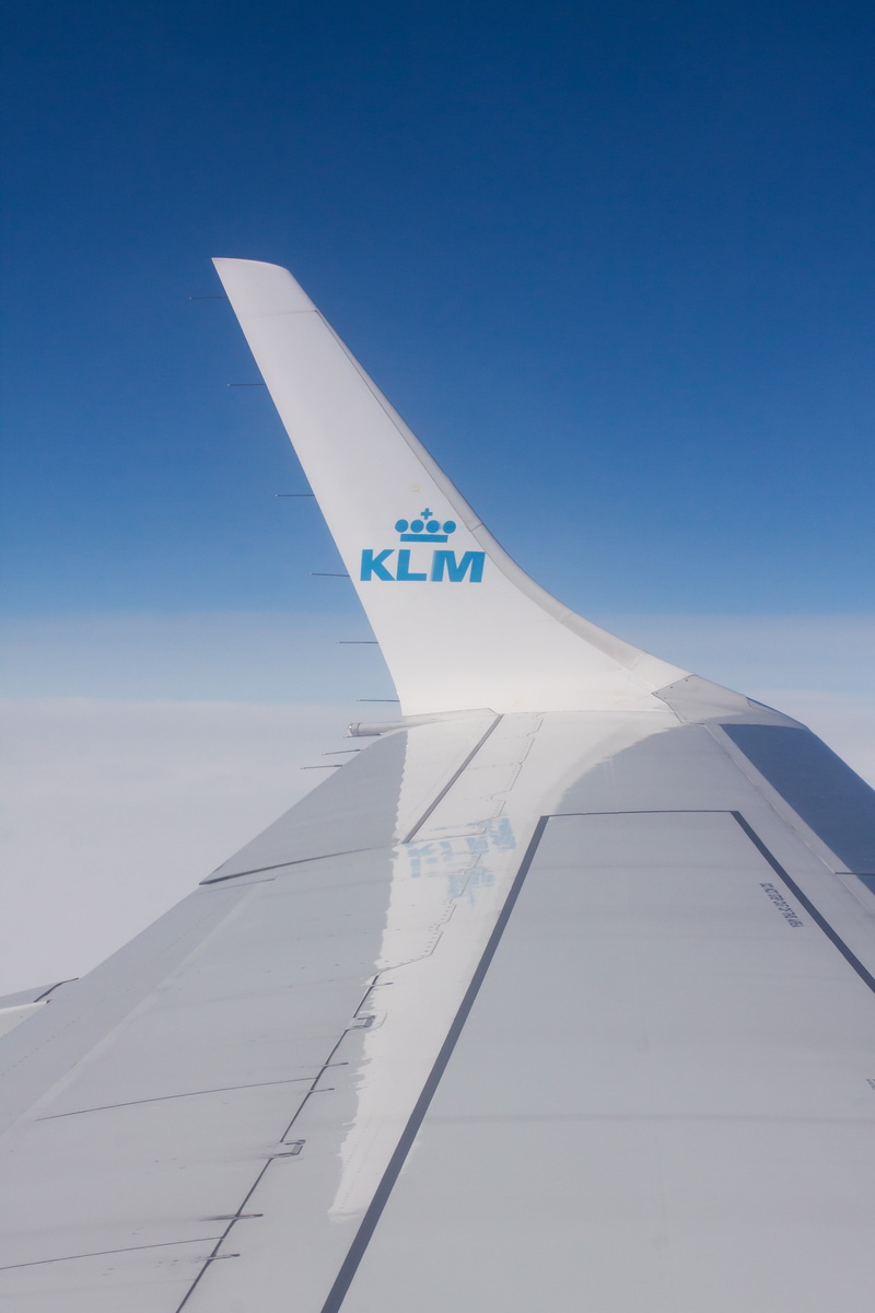 outdoors, sky, 4K, altitude, klm, mirroring, day, plane, flying, white color, sunlight, transport, flight, aircraft wing, public transportation, blue
