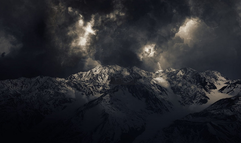 mountain range, storm, tranquil scene, clouds, beauty in nature, mountain, sunlight, cold temperature, winter, Snowy Peak, nature, snow, no people, above