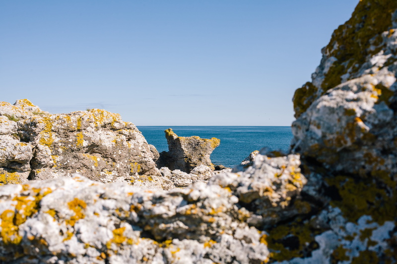 marine, beach, no people, horizon over water, tranquility, clear sky, rauk, sky, rock, tranquil scene, rocky coastline, stone, rock formation, scenics - nature