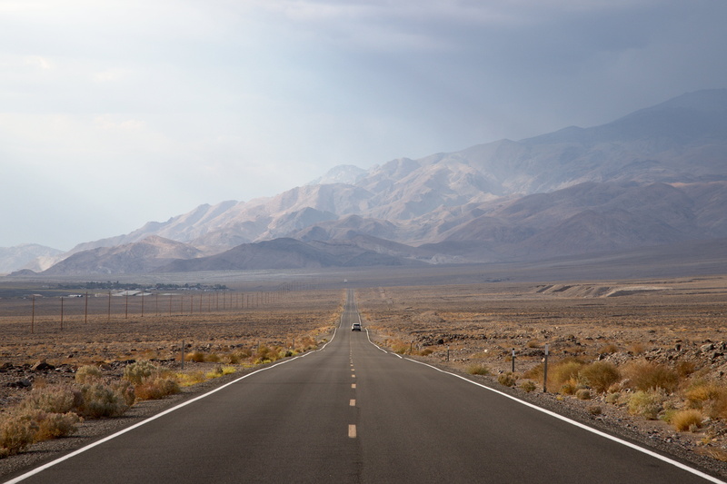 landscape, symbol, scenics - nature, asphalt, non-urban scene, dividing line, straight, sign, beauty in nature, going, outdoors, arid climate, mountains