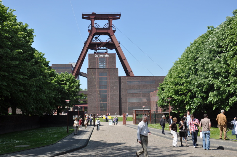 headframe, architecture, heavy industry, day, clear sky, tower, travel, adult, outdoors, people, city, visit, walking, hard coal, sky, plant, building exterior