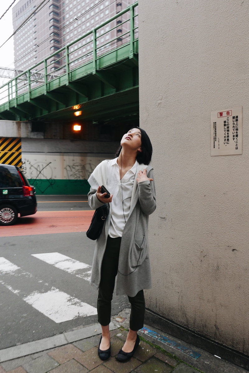young adult, casual clothing, japan, technology, white, leisure activities, day, wearing, fashion, floor, looking, standing, real people, walking, woman