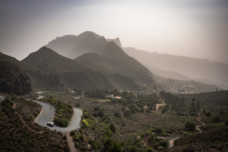 zigzag, fog, tarmac, slope, beauty in nature, outdoors, sky, tranquility, peak, urban, environment, road, building, hill, scenics - nature, transportation