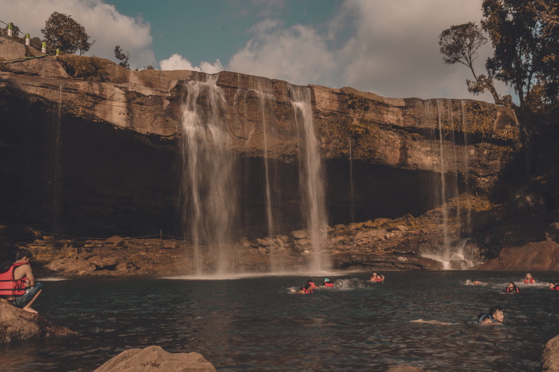 outdoors, water, sky, rock - object, leisure activity, group of people, women, sea, waterfalls, beauty in nature, lifestyles, landscape, flowing water