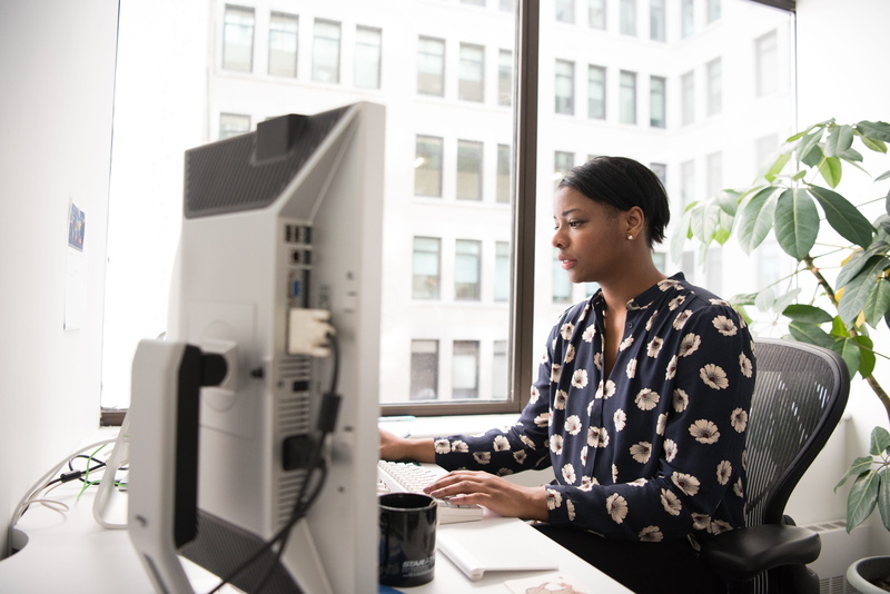 sitting, business person, young women, office, table, indoors, working, using computer, hairstyle, shirt, adult, black, one person, floral, desk, computer