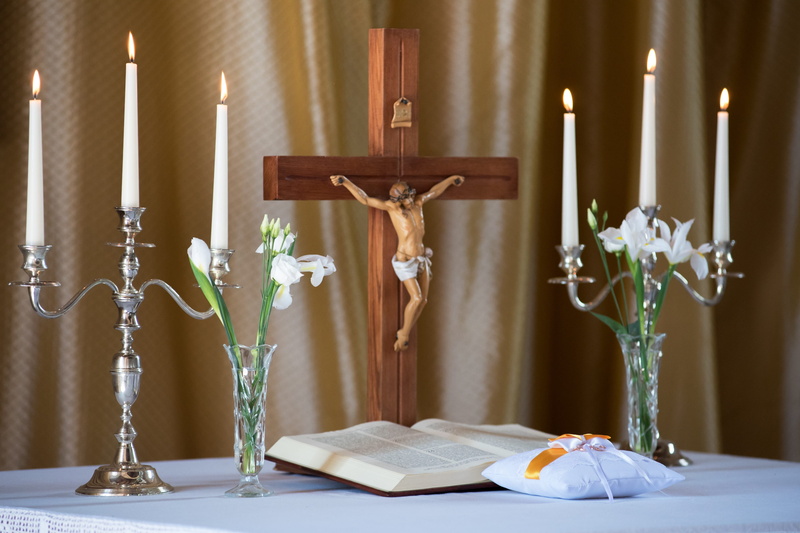 decoration, no people, candlestick, indoors, lighting equipment, electric lamp, 2K, flower, human representation, book, church, religion, vase, cross