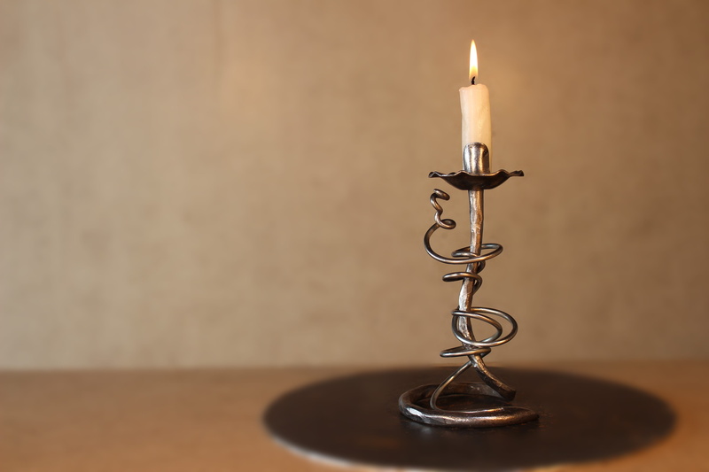 candlestick holder, studio shot, metal, forge, burning, candlestick, flame, stand, electric lamp, brown, wood - material, close-up, wall - building feature
