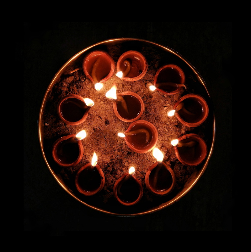 dark, high angle view, 2K, diwali, no people, torch, circle, lights, metal, close-up, studio shot, fire, lighting equipment, diya, burning, geometric shape