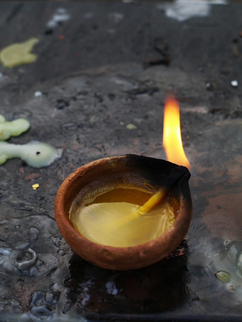 fruit, no people, fire - natural phenomenon, offer, diya - oil lamp, heat - temperature, oil lamp, melting, high angle view, food and drink, India, burning
