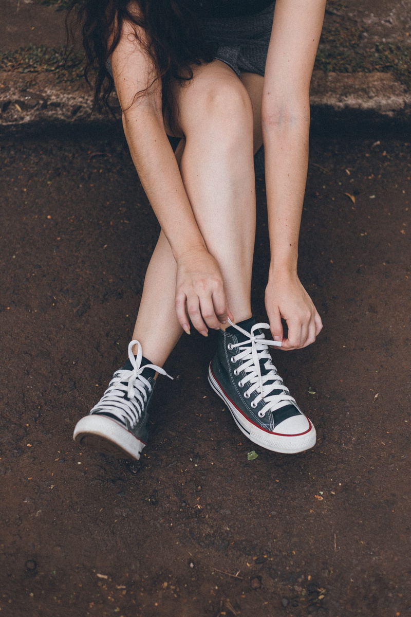 shoelaces, hairstyle, fashion, day, sitting, lifestyles, legs, adult, canvas shoe, human foot, one person, women, shoe, sneakers, woman, photo, human leg