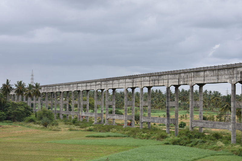 rail transportation, connection, transportation, landscape, architectural column, arch bridge, no people, brown, sky, architecture, cloud - sky, tree, grass