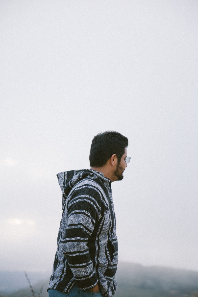 apparel, alone, casual clothing, sweater, t-shirt, wearing, real people, young men, standing, profile view, outdoors, loneliness, person, jacket, black
