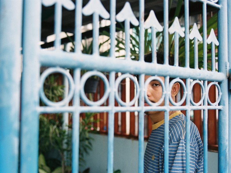 fence, feel, outdoors, real people, portrait, white, pattern, portra, kodak, text, one person, blue, casual clothing, metal, shirt, building exterior, security