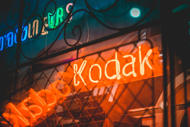 light - natural phenomenon, sign, night, 5K, low angle view, led, kodak, multi colored, outdoors, close-up, lighting equipment, built structure, architecture