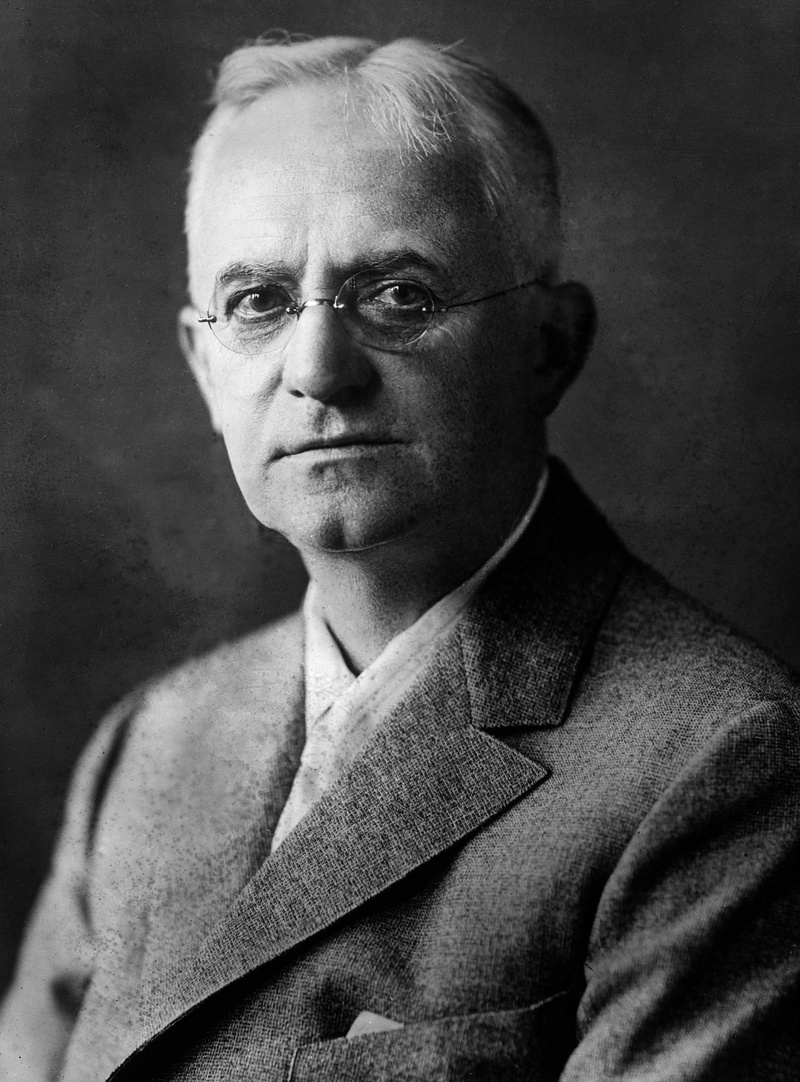 glasses, portrait, roll film popularized, indoors, 2K, lifestyles, one person, men, looking at camera, senior adult, entrepreneur, george eastman, real people