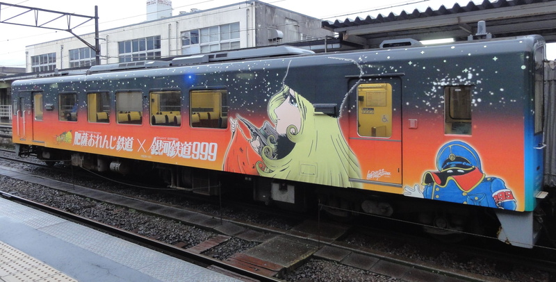 railroad car, mode of transportation, railroad station, building exterior, land vehicle, travel, architecture, Leiji Matsumoto, no people, built structure
