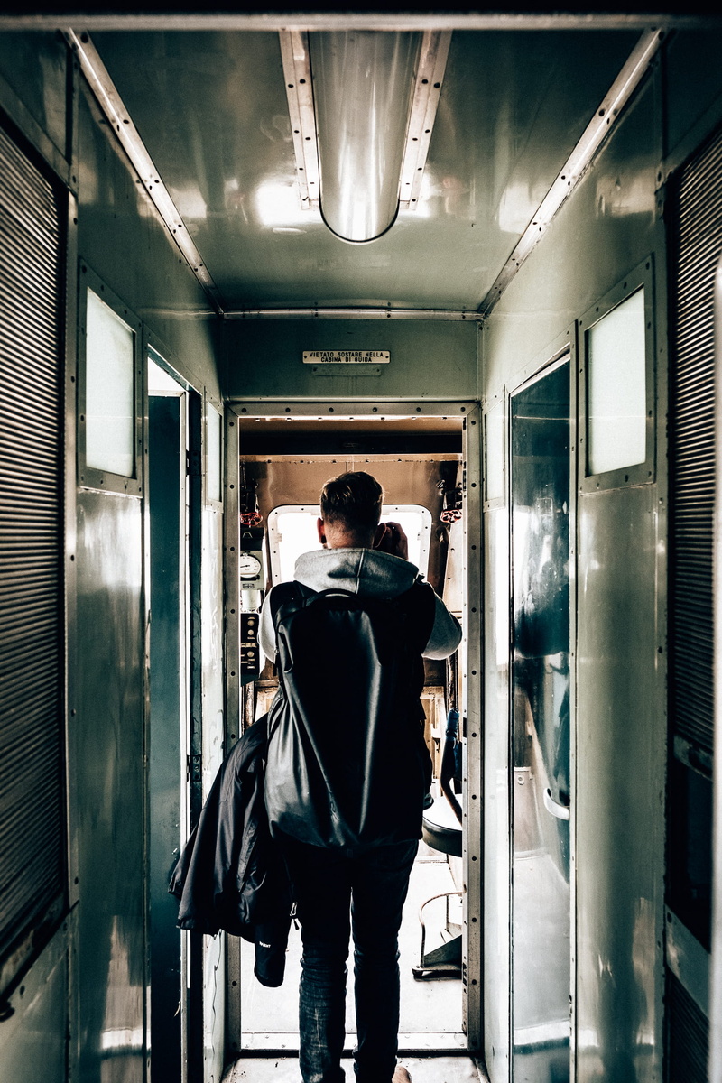 casual clothing, business, trieste, rear view, arcade, illuminated, man, train, ceiling, lighting equipment, men, full length, 2K, indoors, standing, one person