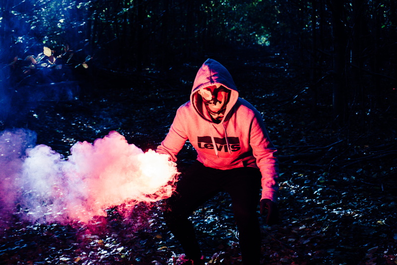 forest, mask, plant, tree, colored smoke, full length, frederikssund, land, 5K, portrait, looking at camera, front view, hood - clothing, mouth open, smoke grenade