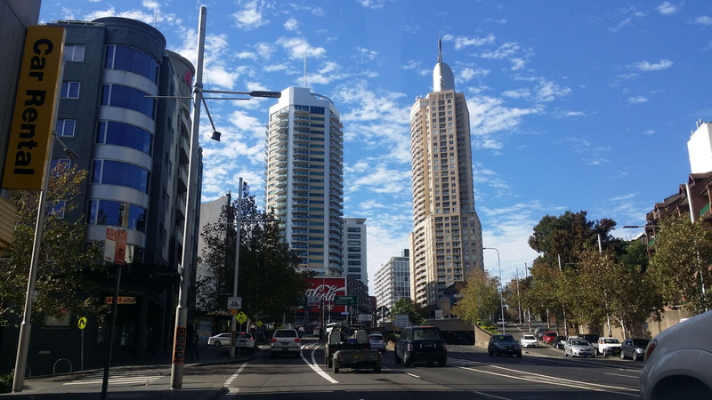 blue sky, modern, tall - high, land vehicle, sign, summer, building exterior, motor vehicle, sydney, building, road, cityscape, transportation, skyscraper