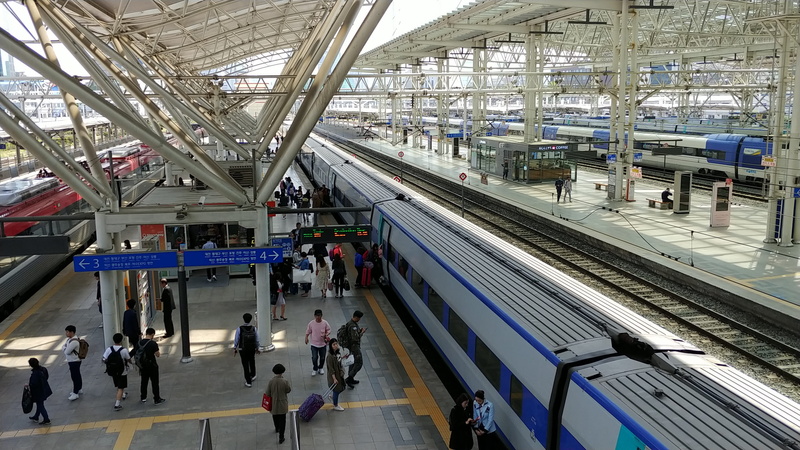 adult, train - vehicle, ceiling, rail transportation, men, mode of transportation, real people, railroad station, waiting, public transportation, ktx, architecture