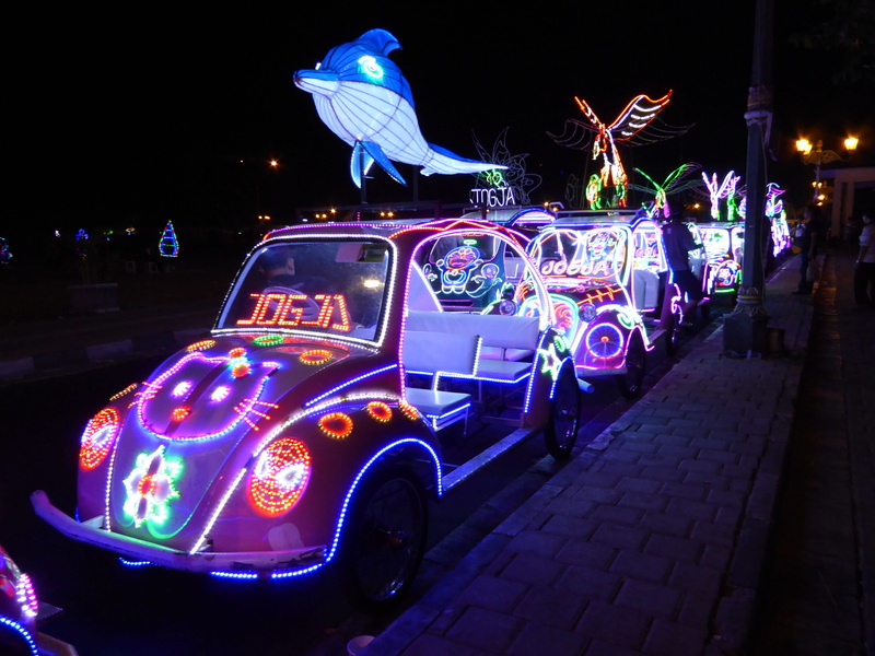 parked, nightlife, illuminated, real people, motion, group of people, city, night, cars, architecture, asia, Indonesia, incidental people, transportation
