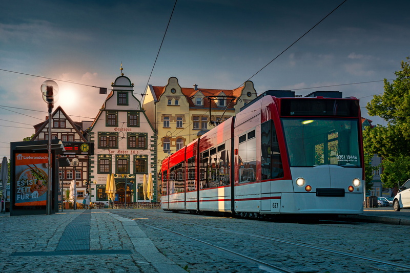 light, transportation, sky, incidental people, mood, tram, historically, building exterior, cloud - sky, mode of transportation, electricity, street, historic old town