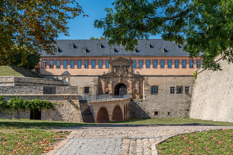 tourism, places of interest, built structure, outdoors, castle, fortress, downtown, facade, sunlight, city, old, sky, plant, landmark, building exterior