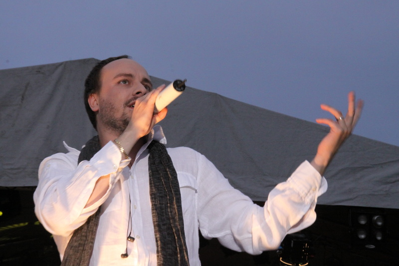 looking away, sing, staging, stage, arms raised, tour, beard, music, looking up, song, adult, young adult, front view, outdoors, day, mood, looking, well-dressed