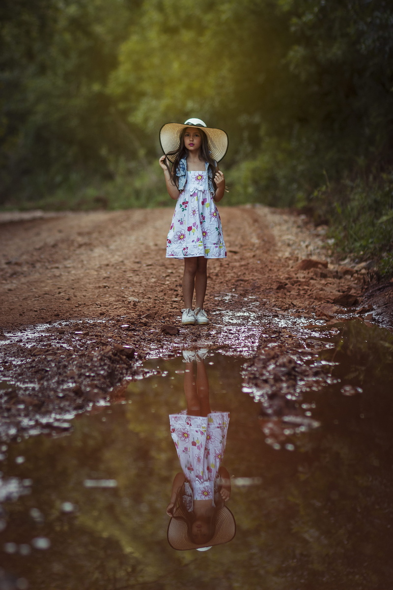 little girl, pose, outdoors, standing, leisure activity, girls, puddle, reflection, long hair, real people, surrounded, front, hair, sun hat, child, innocence