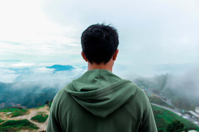 one person, hood, person, cloud - sky, genting, looking at view, nature, sweater, mountain, human, clothing, genting highlands, land, view, sleeve, non-urban scene