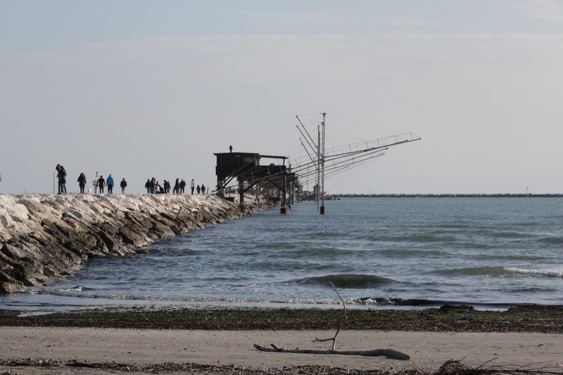 built structure, architecture, motion, outdoors, sky, beauty in nature, group of people, real people, nature, rock, groyne, land, sottomarina, scenics - nature