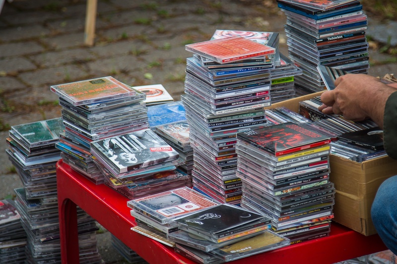 one person, human body part, flea market, large group of objects, men, arrangement, entertainment, audio, publication, adult, 2K, business, cd, cd cover