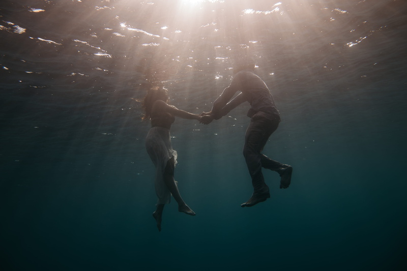 two people, togetherness, clothing, elopment, lifestyles, sea, couple, nature, love, man, ocean, men, bodies, hands, afloat, day, sunlight, arms raised