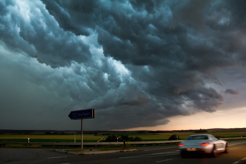 mode of transportation, silver, greenish, road trip, cloud - sky, blurred motion, outdoors, natural phenomenon, wind, dark, motion, coupe, thunderstorm