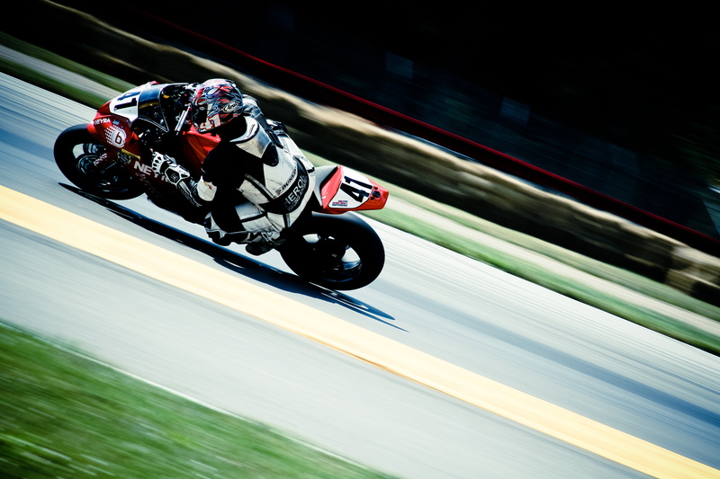 motor racing track, sign, red, helmet, crash helmet, motorsport, movement, driving, sport, headwear, speed, motorcyclist, motor vehicle, sports, motion
