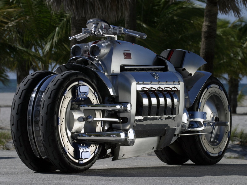 tire, focus on foreground, metal, silver colored, gray, outdoors, no people, wheel, 720P, Motorcycles, land vehicle, tree, street, Dodge, tomahawk, motorcycle