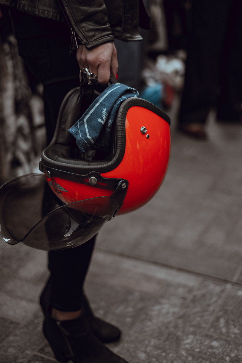 safety, helmet, protection, holding, leather, day, red, human limb, close-up, hand, human leg, girl, incidental people, standing, one person, half, government