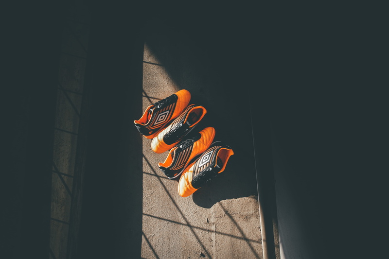 cleats, shadow, chinese new year, orange color, traditional festival, soccer, two, illuminated, outdoors, football, nature, animal representation, shoes