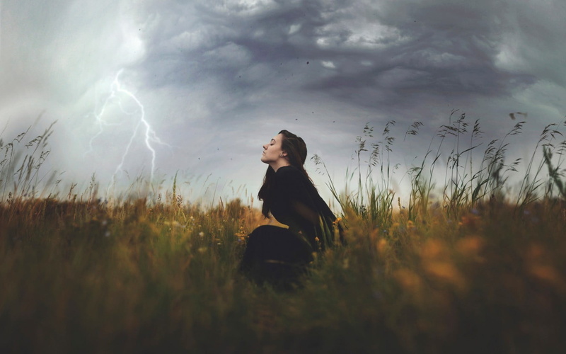 closed eyes, clouds, casual clothing, lightning, young women, beautiful woman, sky, sitting, one person, lifestyles, 720P, grass, three quarter length