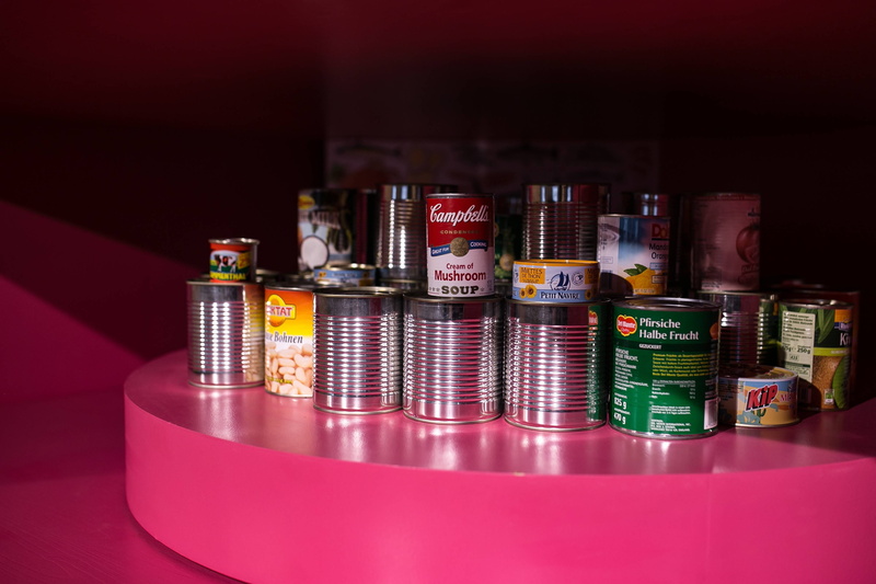 food and drink, in a row, metal, red, gallery, indoors, variation, drink, multi colored, art installations, large group of objects, table, design, finance