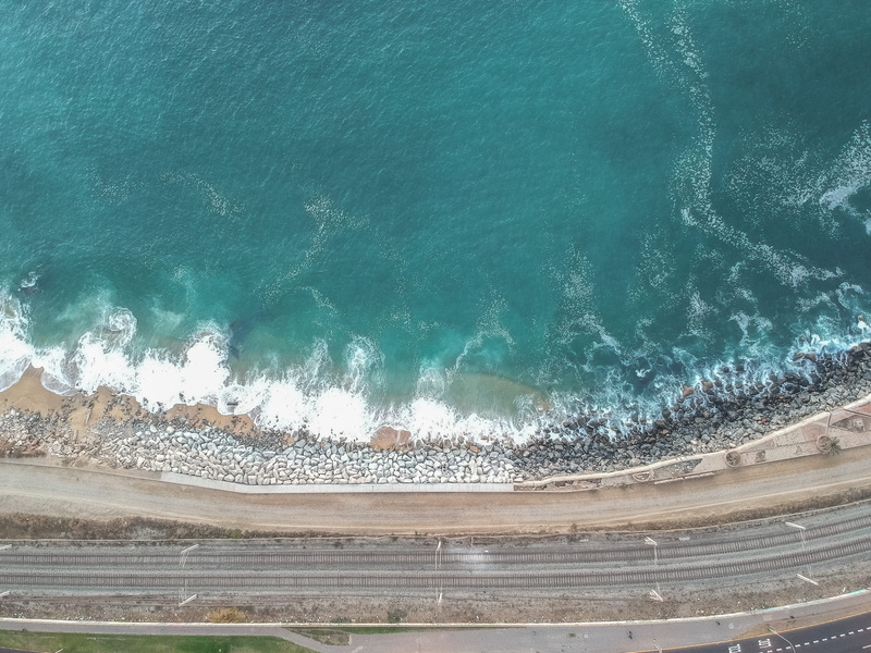 tsunami, outdoors, sunlight, highway, wave, sea, coast, water, aerial view, high angle view, tranquil scene, shoreline, land, daytime, road, nature, river