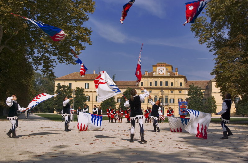 Boys, sky, twirling, adult, building, crowd, day, nature, large group of people, flags, girls, built structure, flag, group of people, real people, building exterior