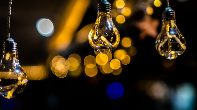 illuminated, food and drink, bulbs, hanging, black background, focus on foreground, lighting equipment, glass - material, decoration, focus