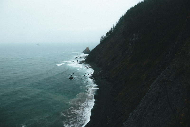 rock, cliff, solid, storm, mountains, sea, beauty in nature, fog, sky, beach, mountain, day, real people, mist, land, high angle view, scenics - nature