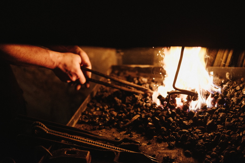 4K, glowing, heat, adults only, holding, adult, ash, one person, heat - temperature, charcoal, occupation, real people, hand, people, blacksmith, only men